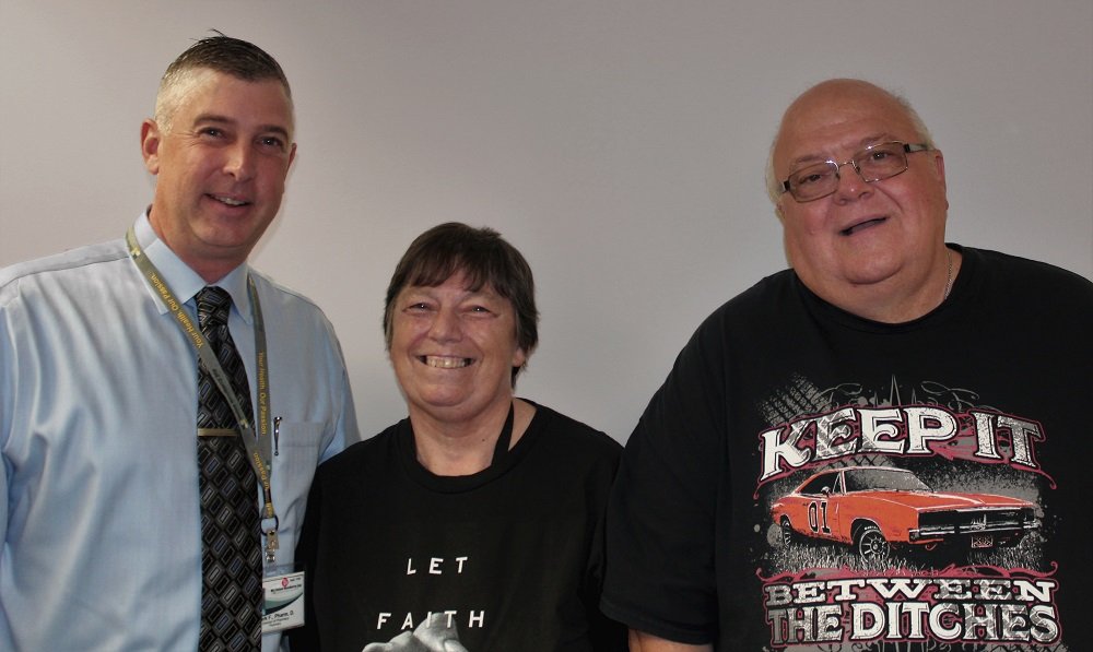 Debbie Case smiles alongside HNJH Pharmacist, Mark Fischer, and husband, Fred.