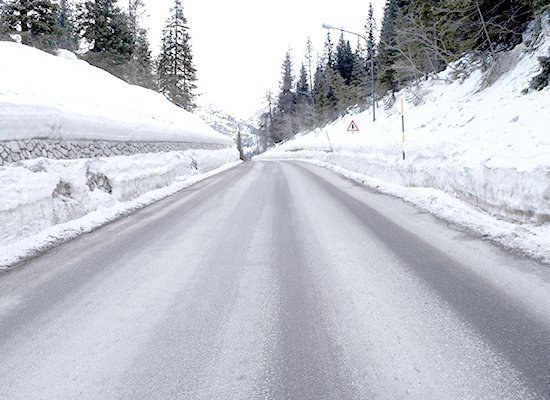 Rural road with a light covering of snow.