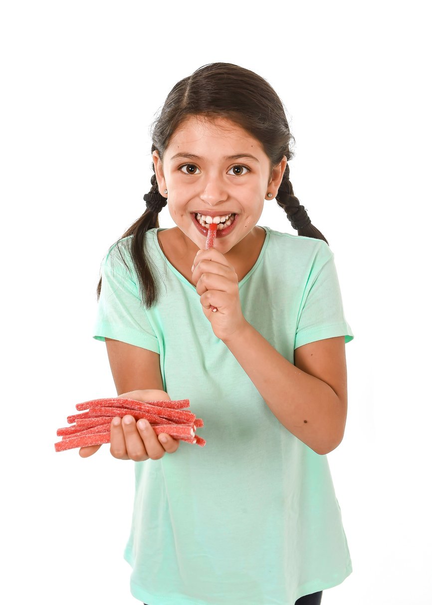 Girl eating red licorice. What is red licorice?