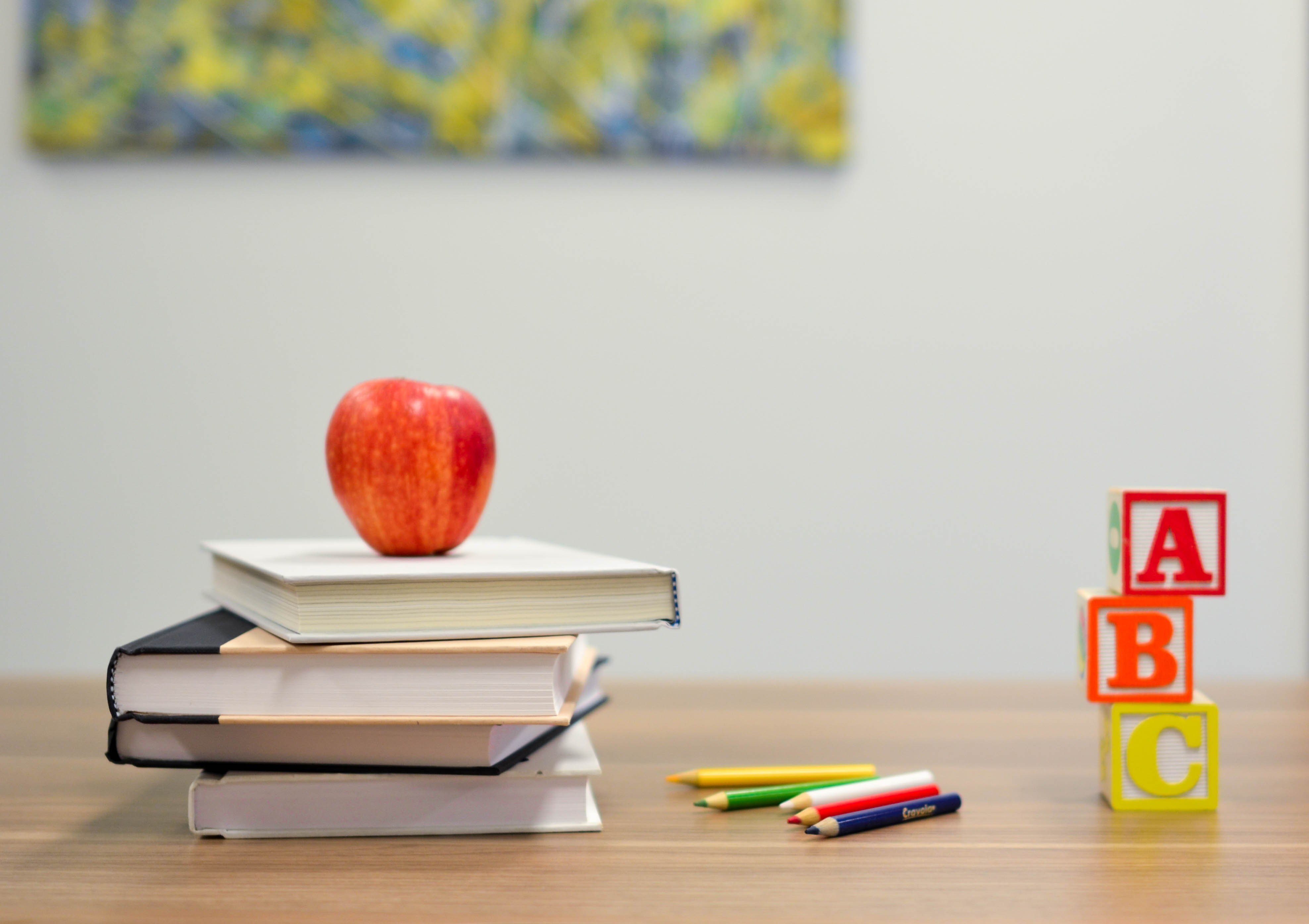 stack-of-books-with-apple-and-blocks